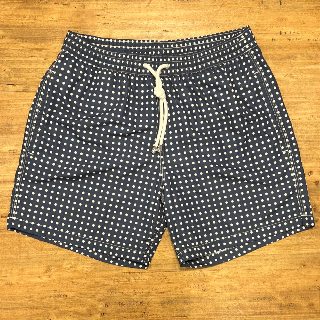 White polka dots on blue swim short