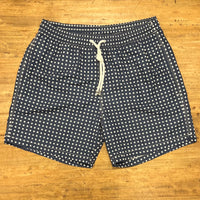 White polka dots on blue swim short