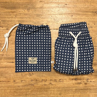 White polka dots on blue swim short